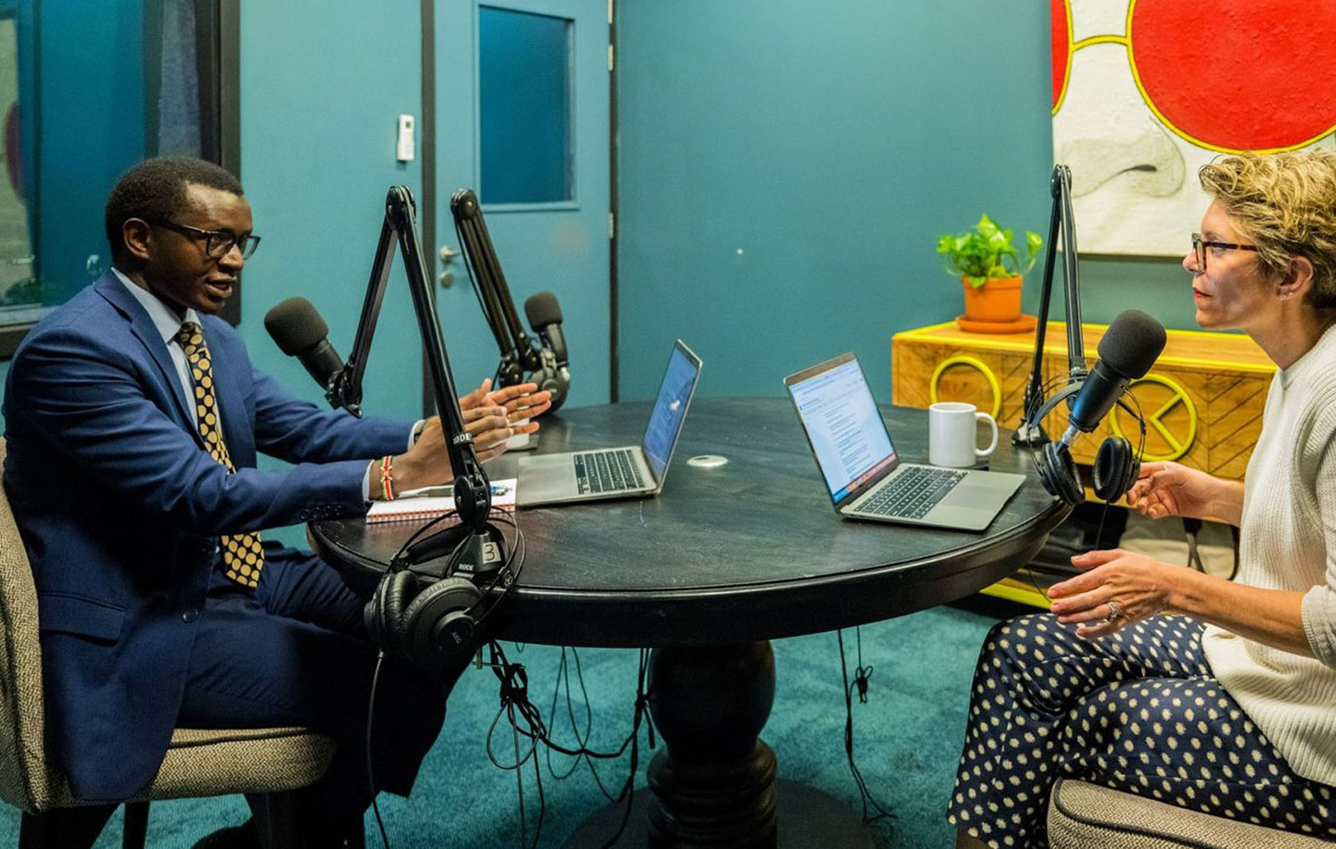 Two people in conversation at a studio table