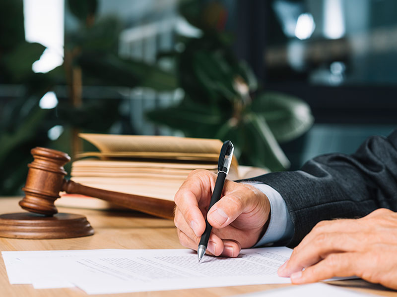 An advocate signing a document